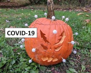 carved pumpkin in the form of a COVID virus