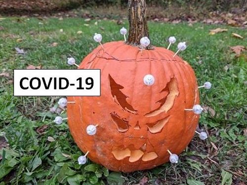 carved pumpkin in the image of a COVID virus cell