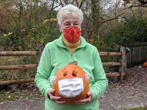 lady holding a carved pumpkin