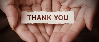 open hands with thank you note