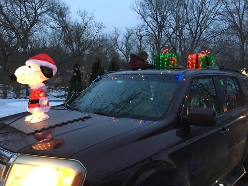  A snoopy inflatable and christmas presents decorate this car in the parade