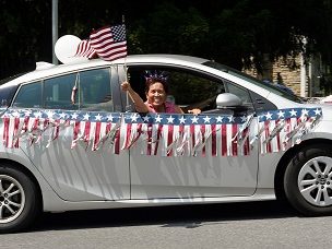 Silver car decorated for 4th of July Parade