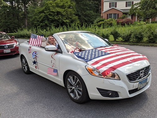 White convertible decorated for 4th of July Parade